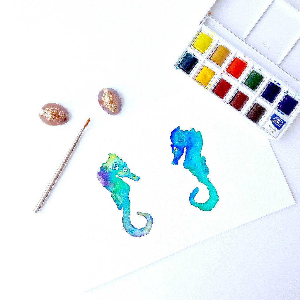 Pair of seahorse painted in cool blues and greens