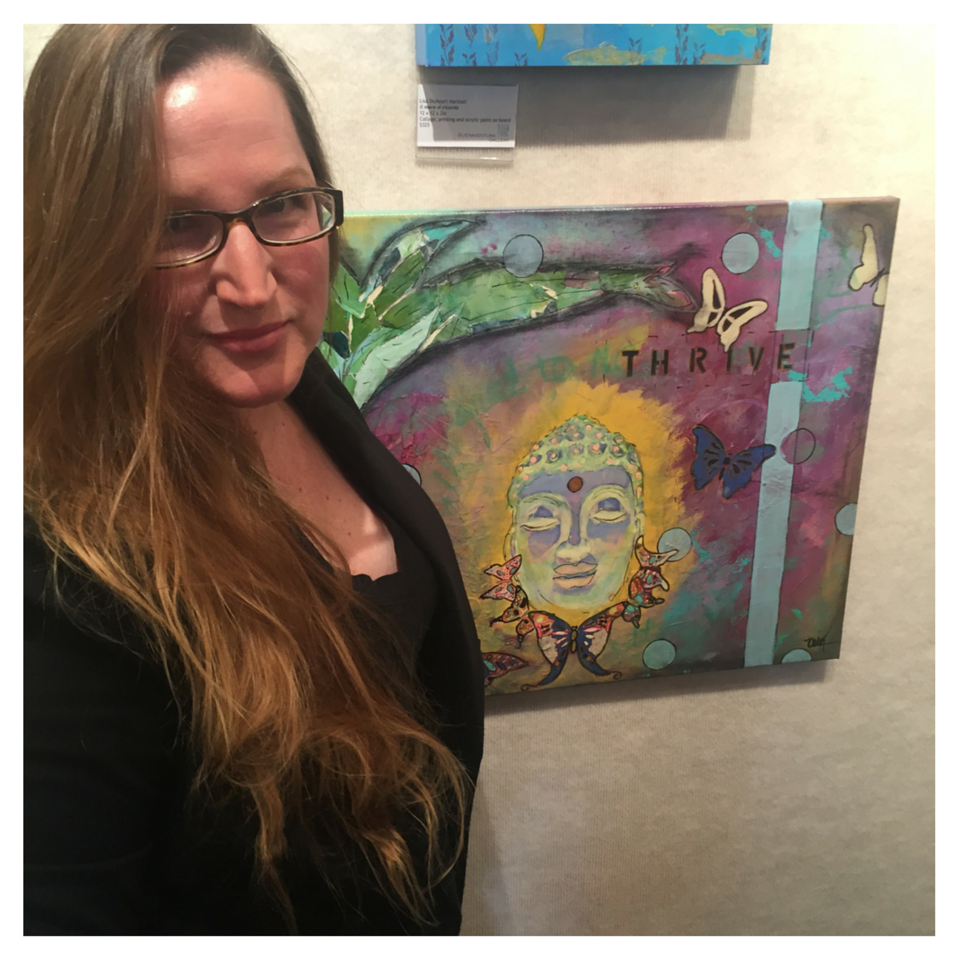 Artist Mika Harmony stands in front of her "Abundance" Buddha painting at the BAA Gallery in Ventura, CA